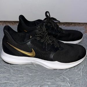 Woman’s size 8 US Nike athletic shoes black & gold